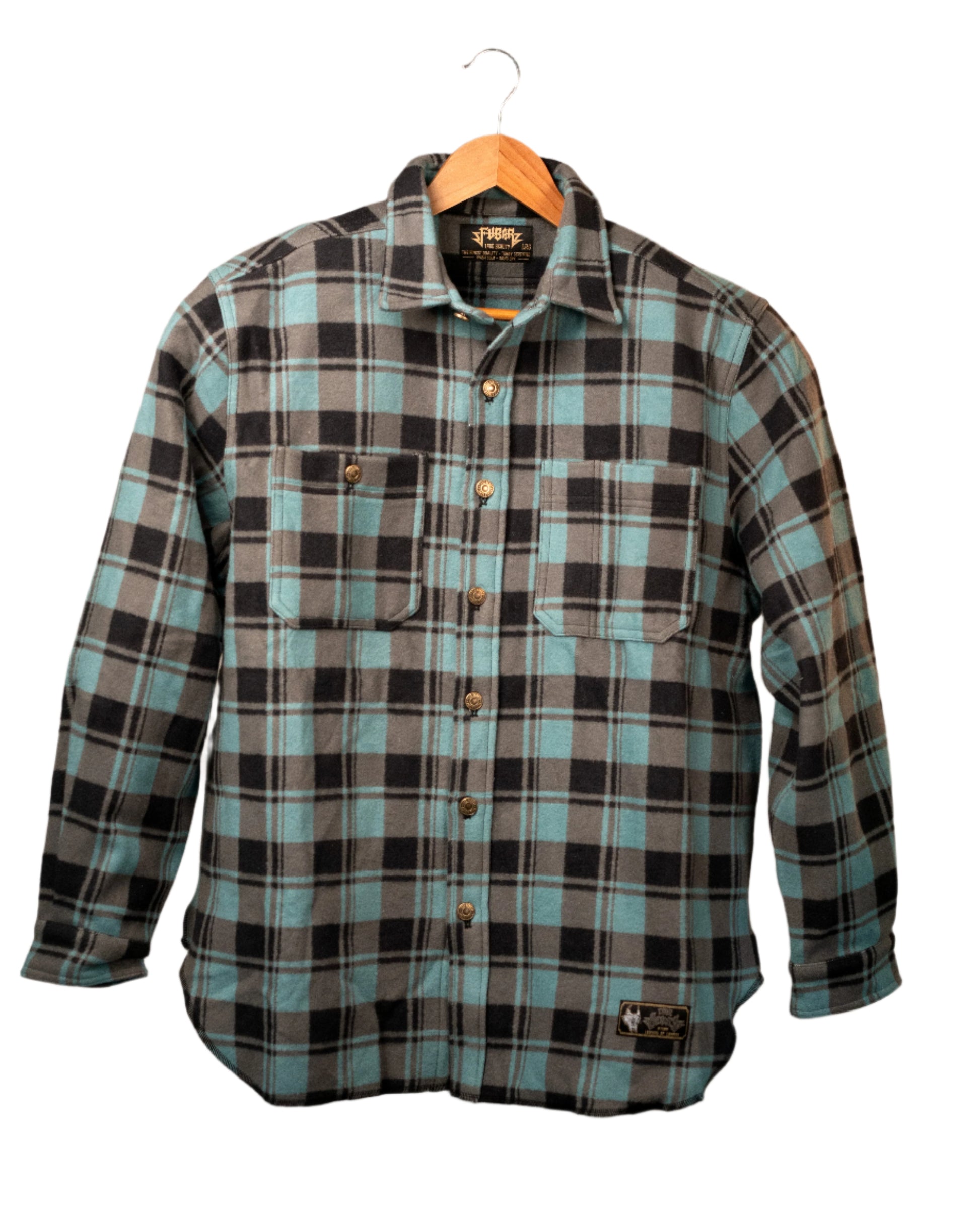 Plaid shirt on a hanger against a plain background