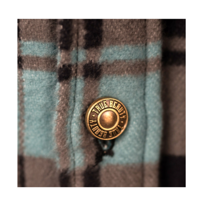 Plaid fabric with a button labeled 'True Beauty' on a checkered background